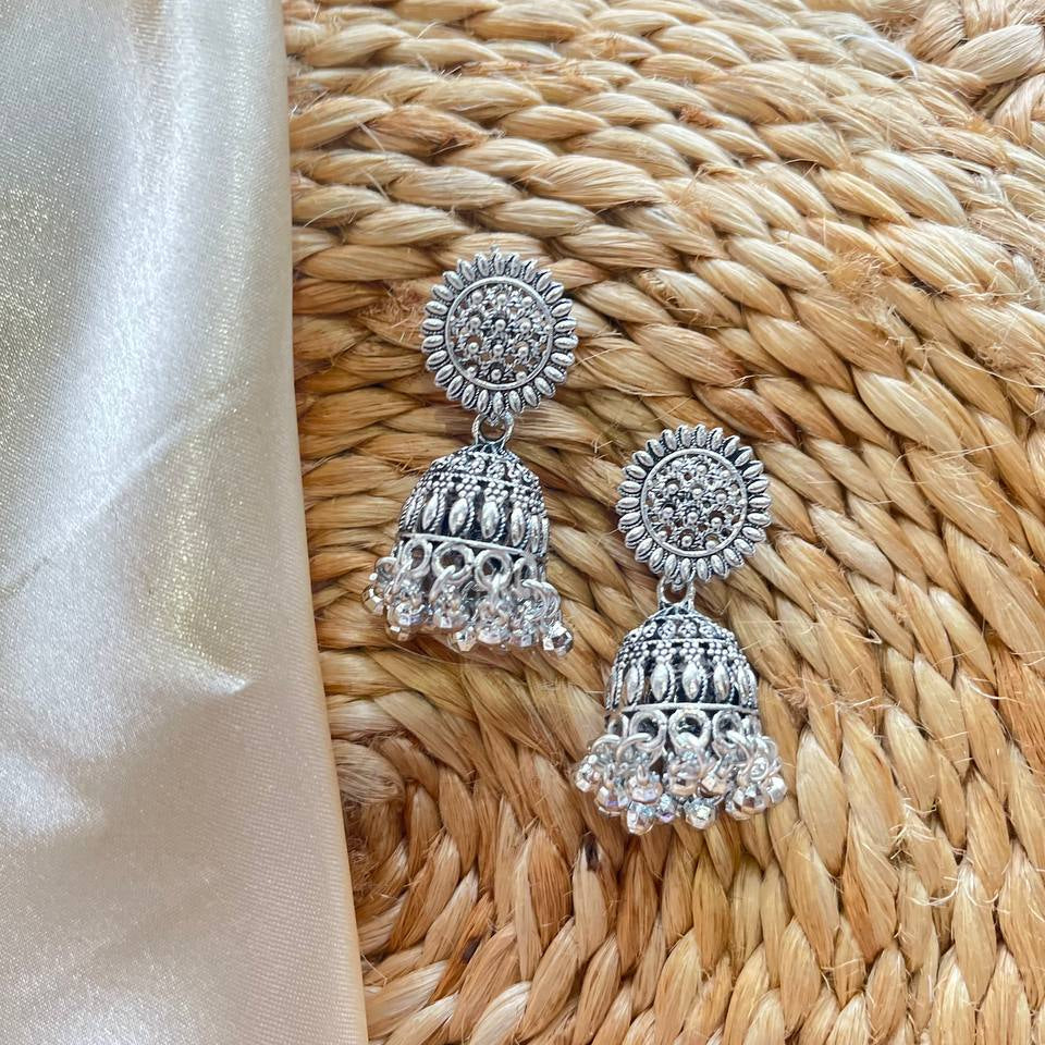 Silver earrings on a textured woven surface Chandra Jhumka Oxidized Earrings 
#MustHaveAccessories
#AccessorizeYourLook
#JewelleryLove
#DailyWearJewellery
#StatementEarrings
#TrendingEarrings 
#Oxidized
#BohoVibes
#SilverVibes
#DesiVibes #tivracreation #tivra #ShopifyStore
#AmazonFindsIndia
#FlipkartFinds
#MeeshoFinds
#OnlineShoppingIndia
#TrendingNowIndia
#SellerOnAmazon
#SmallBusinessIndia