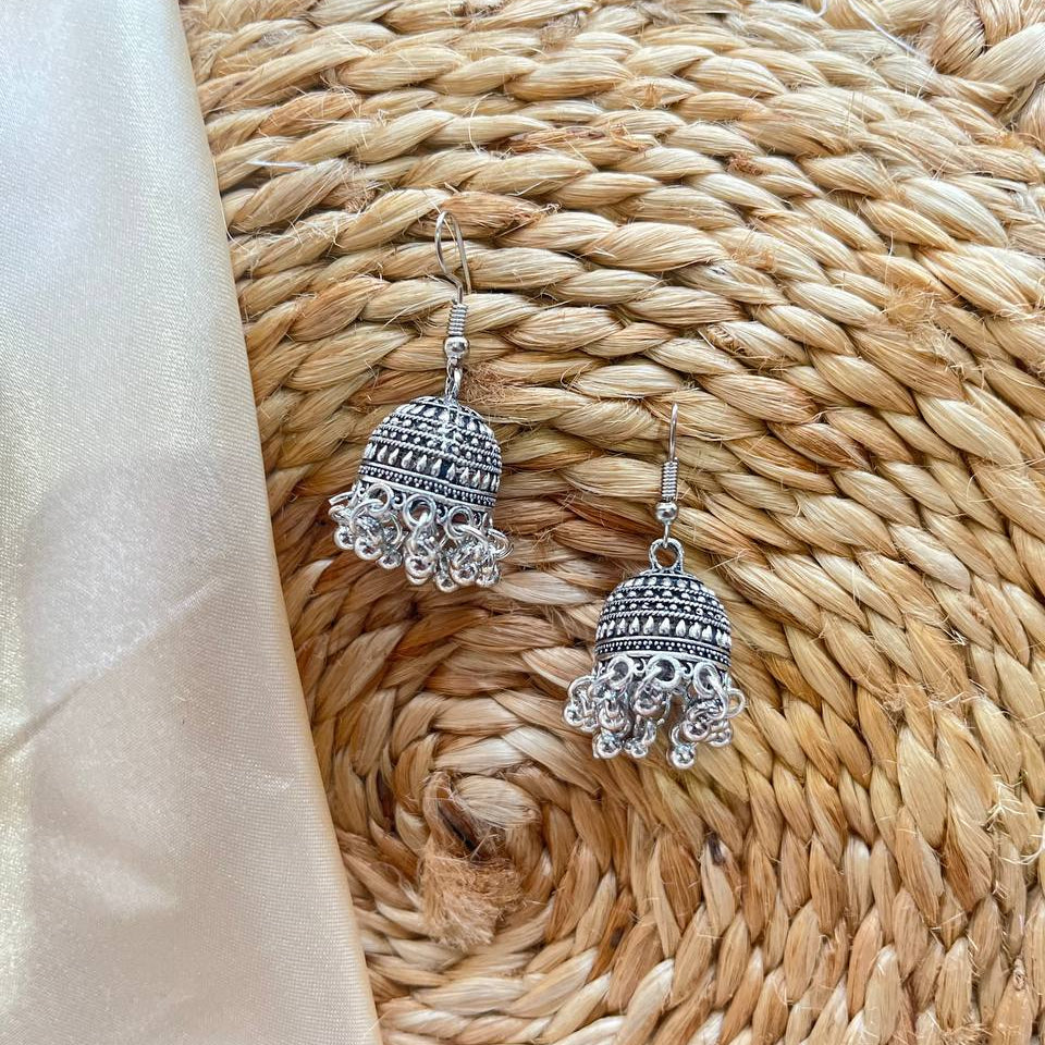Silver bell-shaped earrings on a woven mat 
#IndianJewellery
#TraditionalJewellery
#EthnicLook
#DesiFashion
#IndoWesternLook
#FestivalJewellery
#WeddingJewellery
#BohoJewellery
#SilverJewellery #tivracreation #tivra