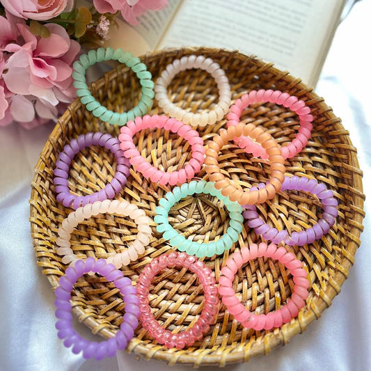 Colorful hair ties on a woven tray with flowers in the background Telephone Rubber Band #TelephoneRubberBands
#SpiralHairTies
#HairAccessories
#NoCreaseHairTies
#HairTrend
#TrendingNow
#OnlineSeller
#ShopifyStore
#FlipkartFinds
#AmazonFinds
#WholesaleHairAccessories
#MadeInIndia
#TrendingNow
#MustHave
#ViralAccessories
#StyleInspo
#OOTD
#HairHacks
#BeautyTrend
#AccessorizeYourLook