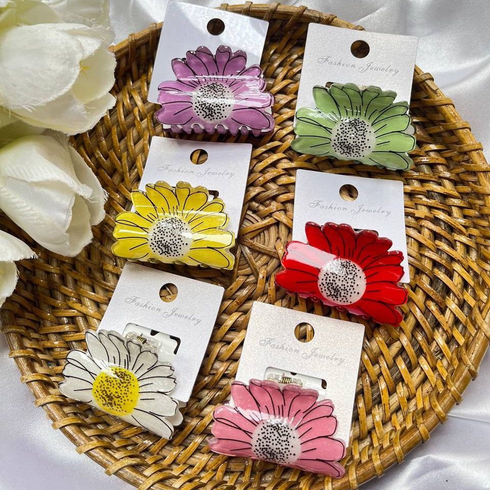Set of colorful flower-shaped hair clips on display with white flowers and a woven tray. Tivra Creation Sunflower claw clips #sunflowerclawclip
#sunflowerhairclip
#clawcliptrend
#hairaccessoriesindia
#hairclipsforsale
#sunfloweraesthetic
#summerhairaccessories
#trendyhairclips
#cutehairclips
#handmadehairclips
#smallbusinessindia
#hairaccessoriesstore
#dailyhairaccessories
#pinterestinspiredhair
#haircareaccessories
#floralhairclips
#shoplocalindia
#onlinestoresindia
#fashionaccessoriesindia
#tivracreation