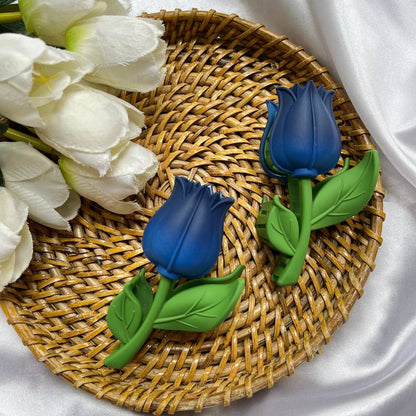 Blue tulip-shaped soaps on a woven mat with white tulips